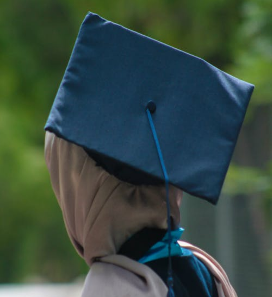 A Person Wearing a Blue Academic Hat